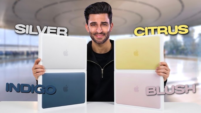 MacBook Neo laptops in silver, blush, citrus, and indigo colors, slightly open and arranged in an arch formation