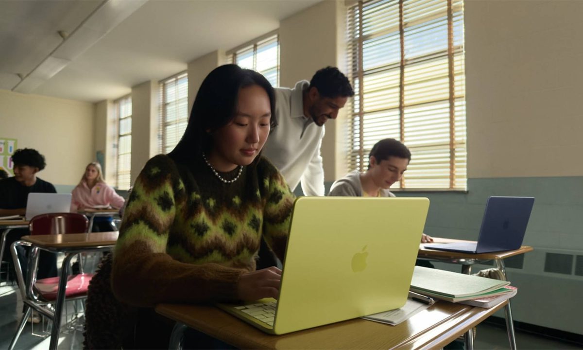 Student using MacBook Neo for note-taking in library