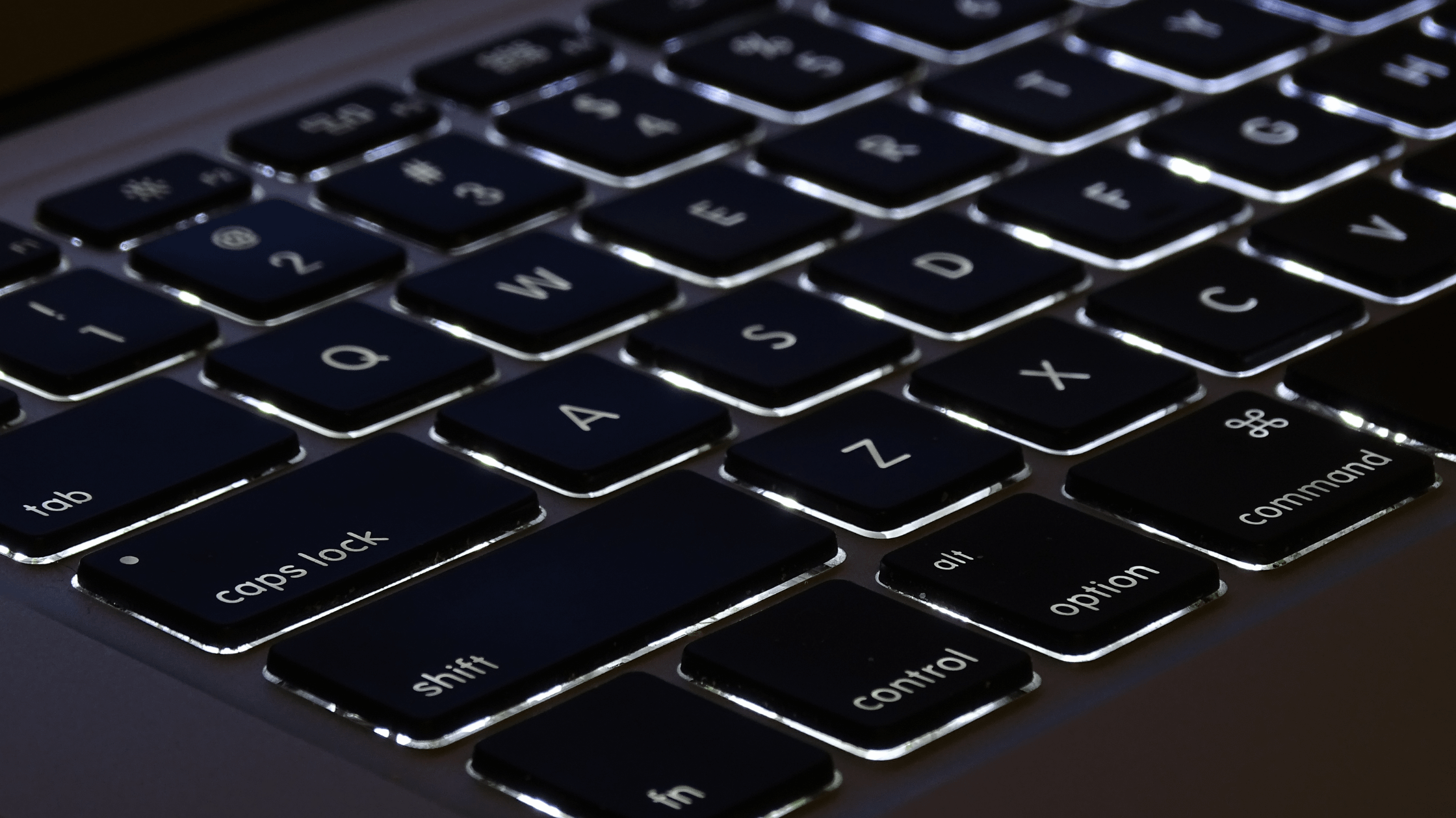 MacBook Neo keyboard without backlight in dim lighting
